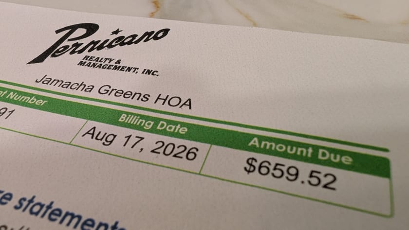 A photograph of a printed assessment statement lying on a counter. At the top left is a logo: the word Pernicano in a sloping script with a star above it, and REALTY & MANAGEMENT, INC. in small capitals beneath. Under the logo, Jamacha Greens HOA. A green table below gives Billing Date, Aug 17, 2026, and Amount Due, $659.52.